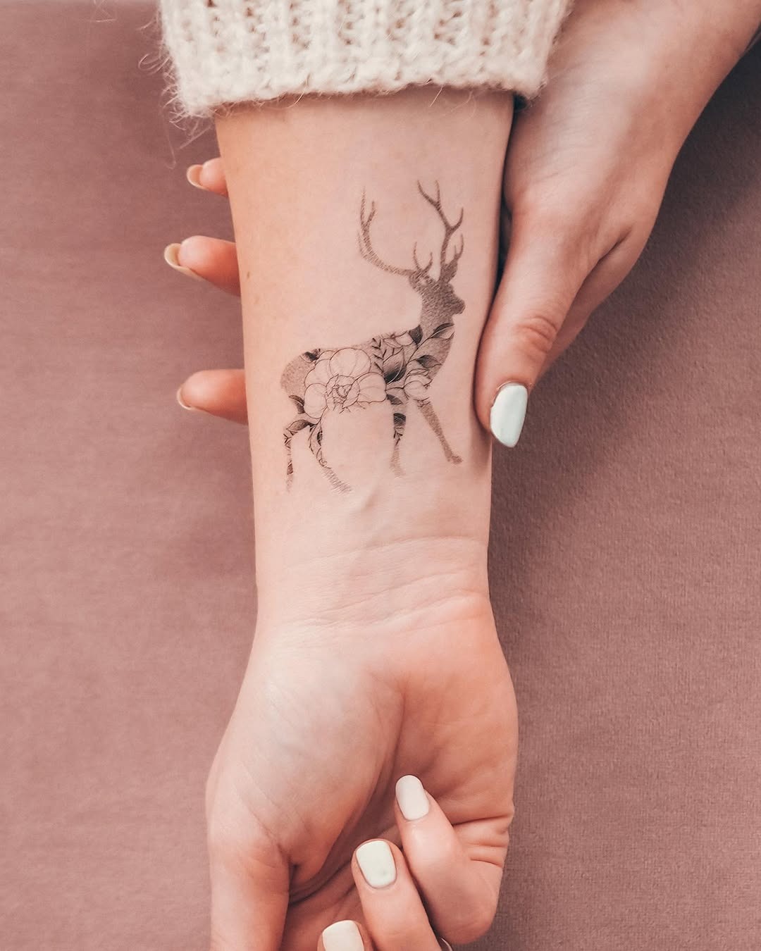 Elegant deer tattoo adorned with floral elements Tattoo Design