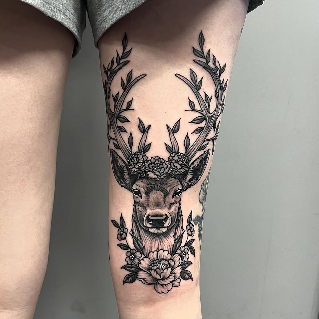 Elegant deer tattoo adorned with flowers Tattoo Design