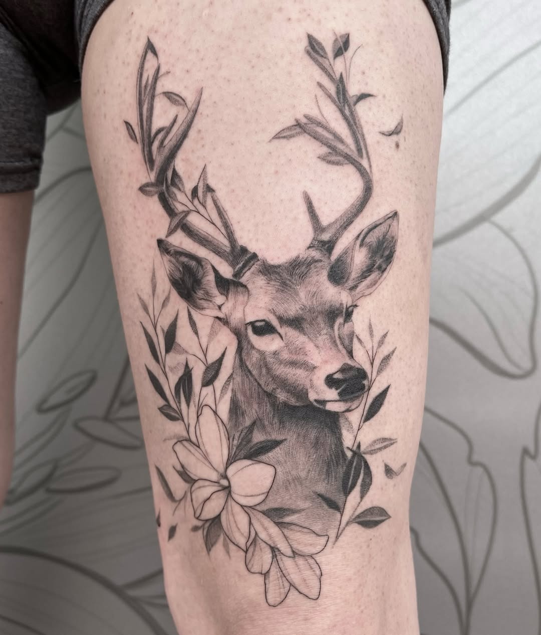Elegant deer tattoo framed by beautiful flowers Tattoo Design