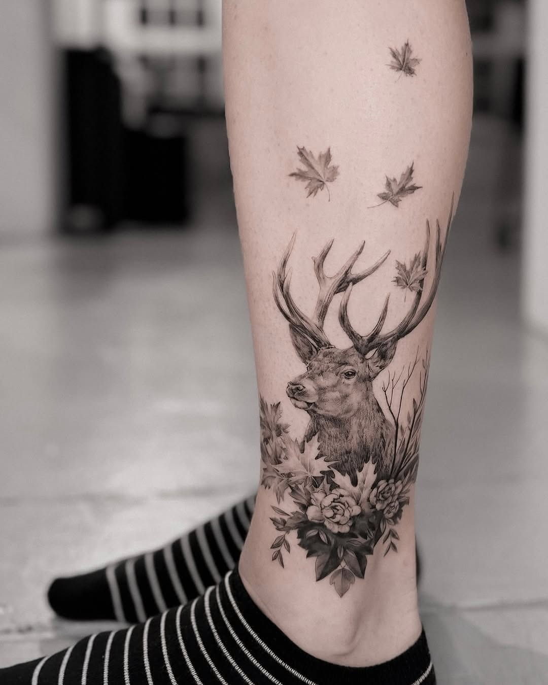 Elegant realistic deer tattoo with floral elements Tattoo Design