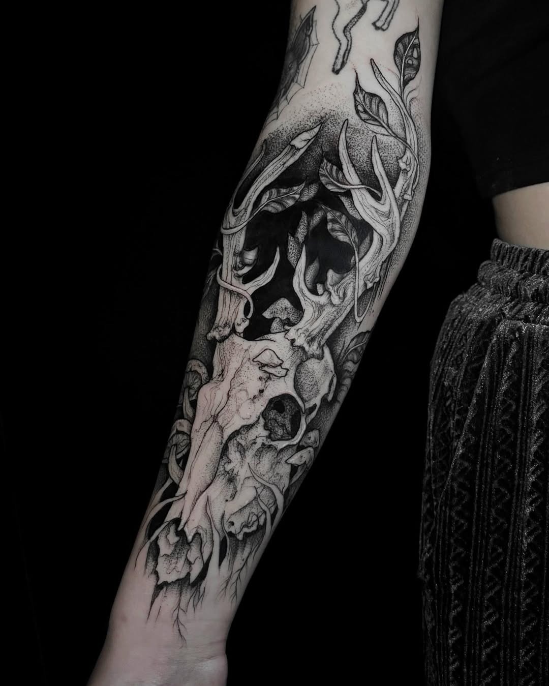 Elegant skull tattoo with floral accents Tattoo Design