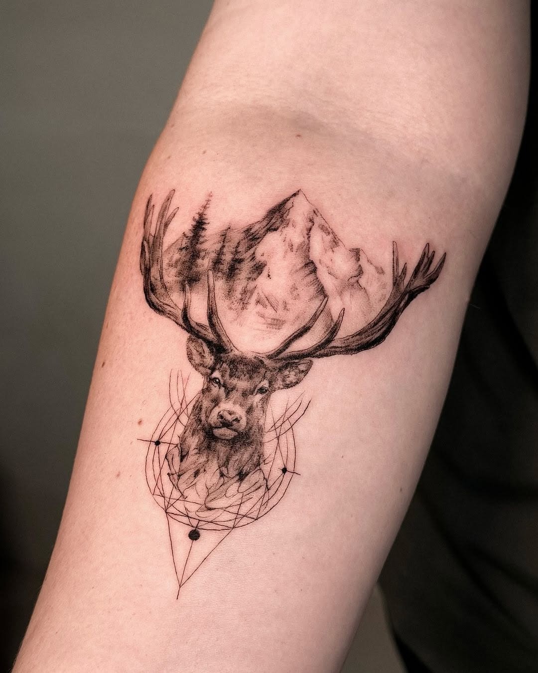 Majestic deer with mountains and geometric accents Tattoo Design