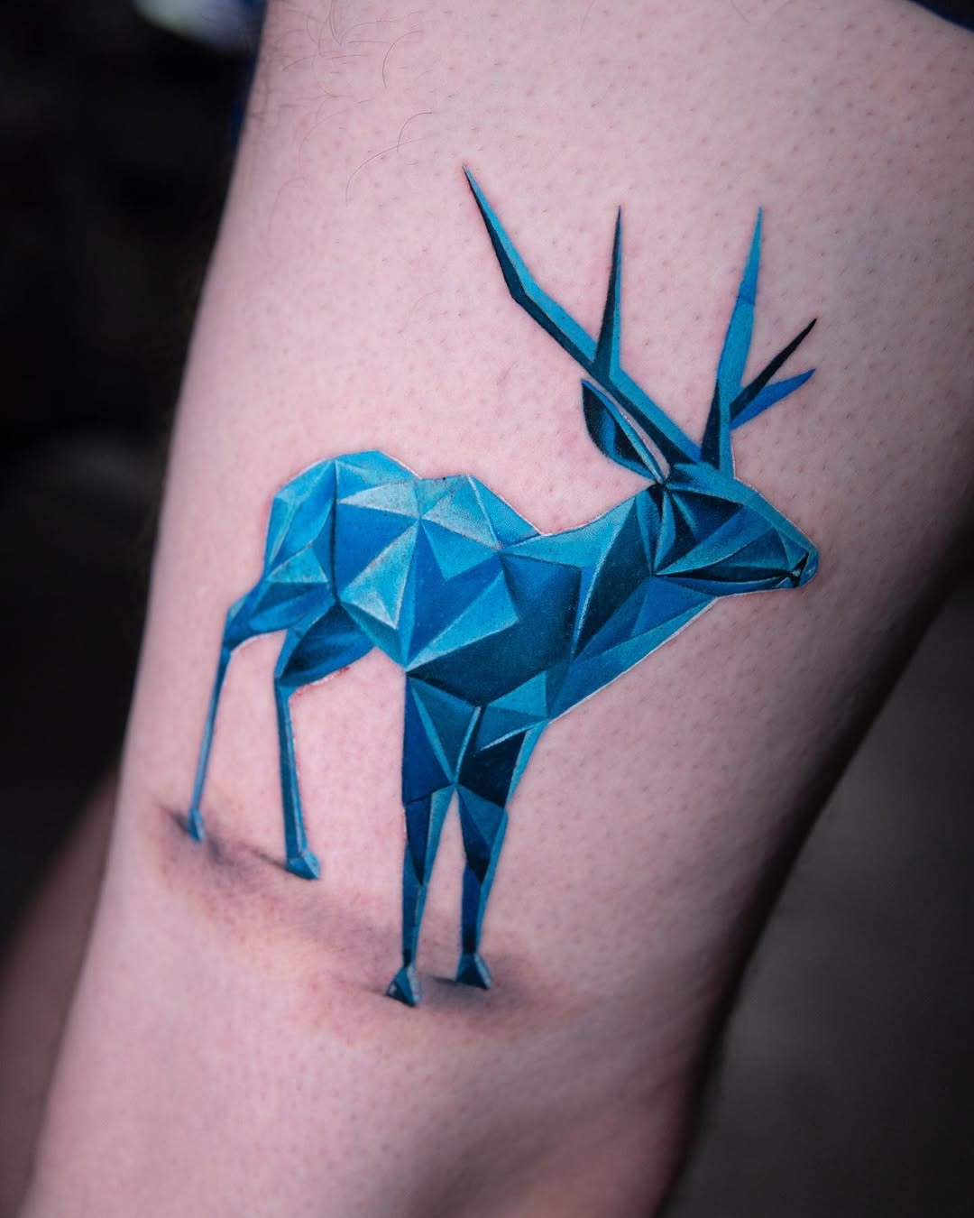 Stunning geometric deer tattoo in vibrant blue Tattoo Design