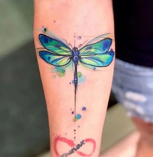 Artistic Expression: Vibrant Forearm Dragonfly Tattoo Design