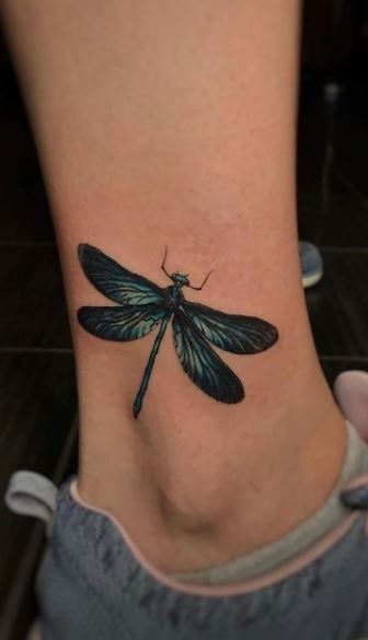 Bold and Striking: The Black Dragonfly on the Ankle Tattoo Design