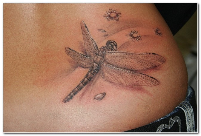 Whimsical and Natural: Dragonfly Tattoo with Floral Elements Tattoo Design