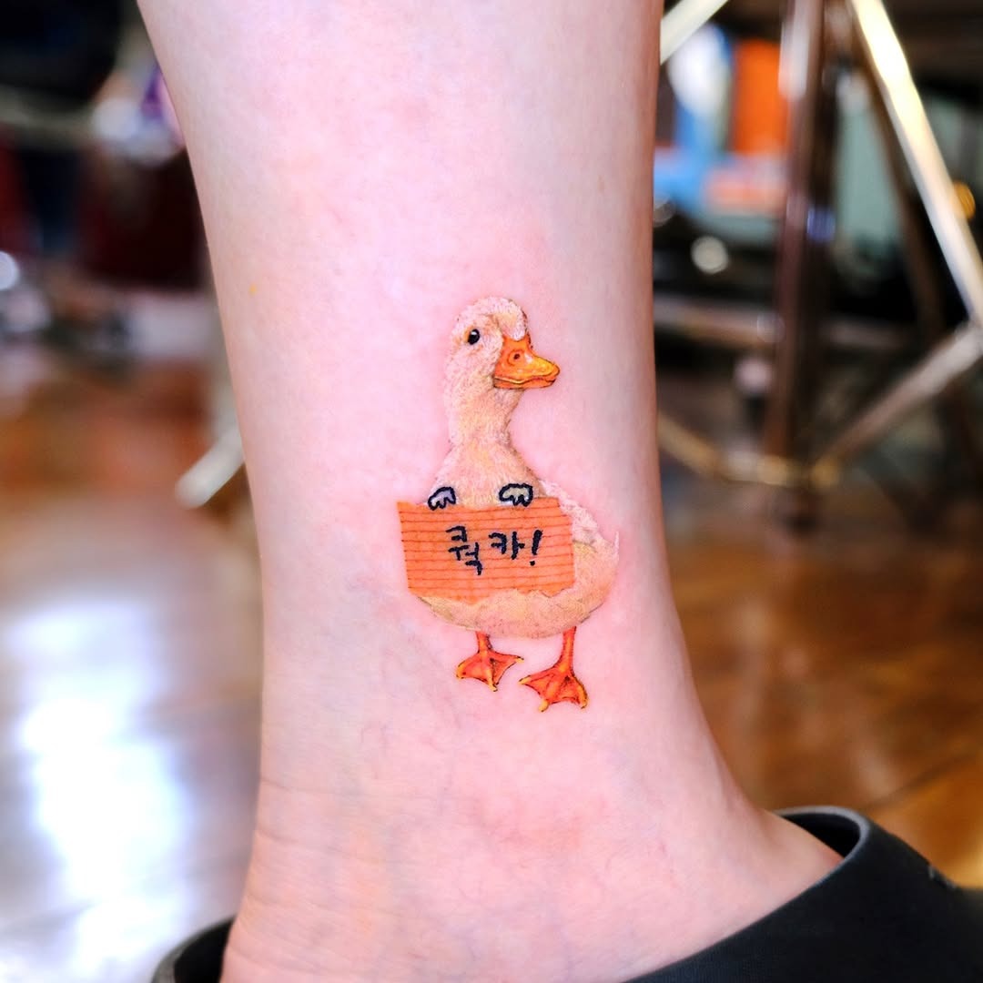 Bright and playful duck inked on the skin Tattoo Design