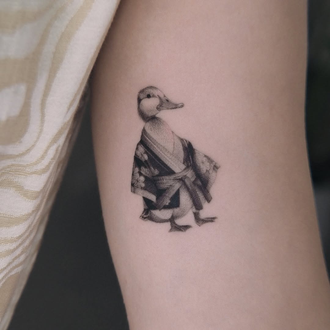 Elegant duck tattoo in traditional attire Tattoo Design