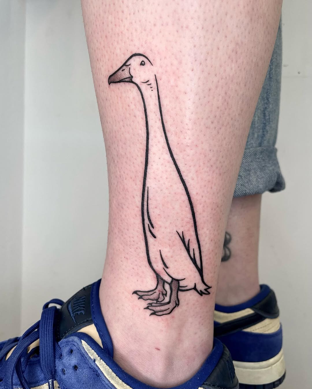 Minimalist duck tattoo with unique character Tattoo Design