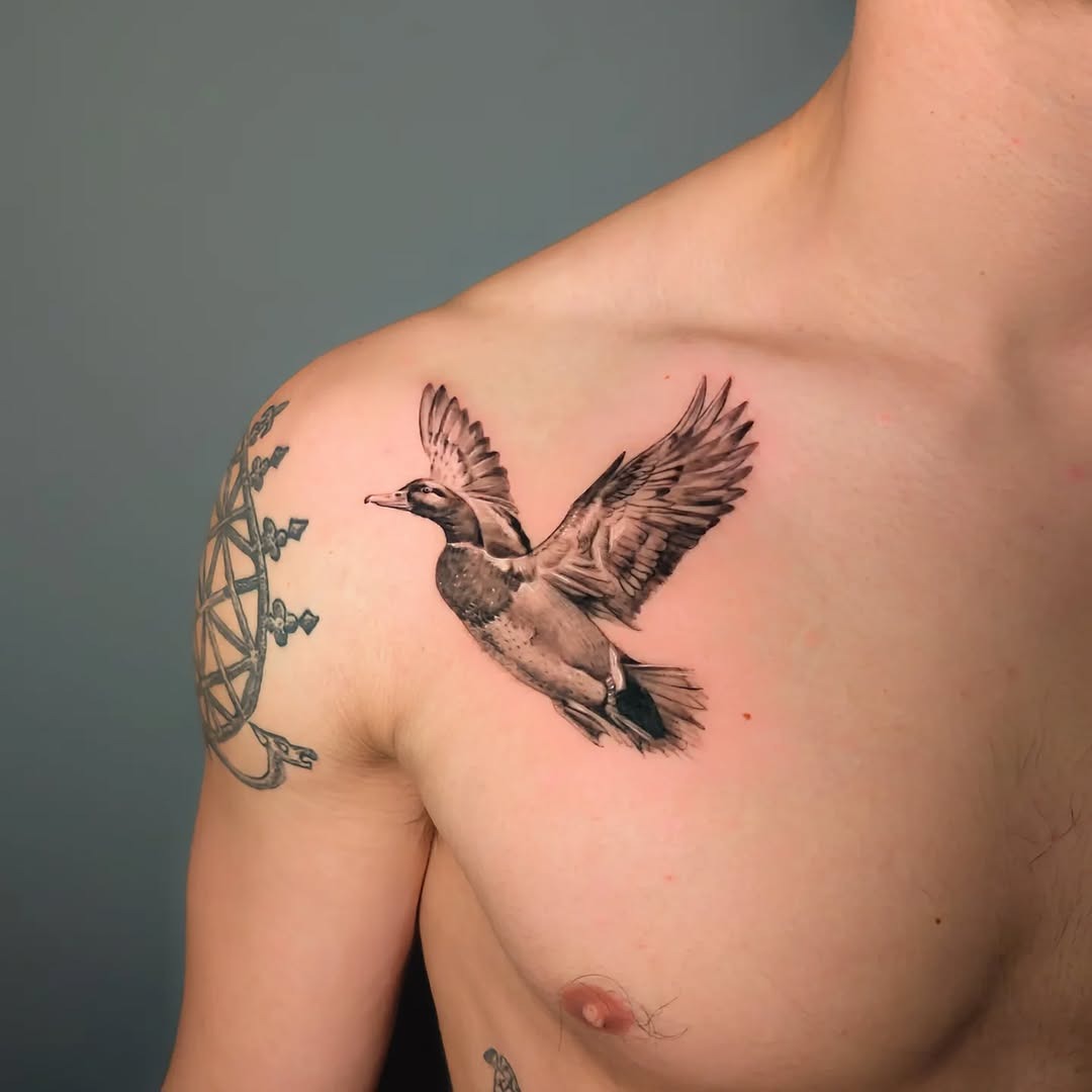 Realistic flying duck tattoo on chest Tattoo Design
