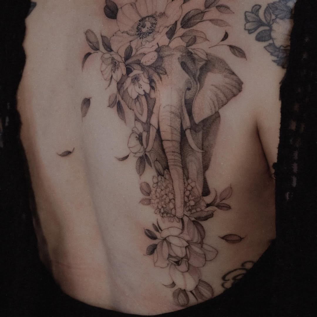 Elegant elephant design with floral elements Tattoo Design