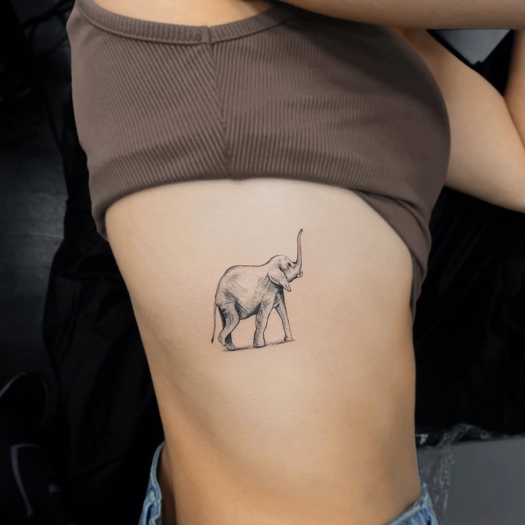Minimalist elephant tattoo on rib cage Tattoo Design