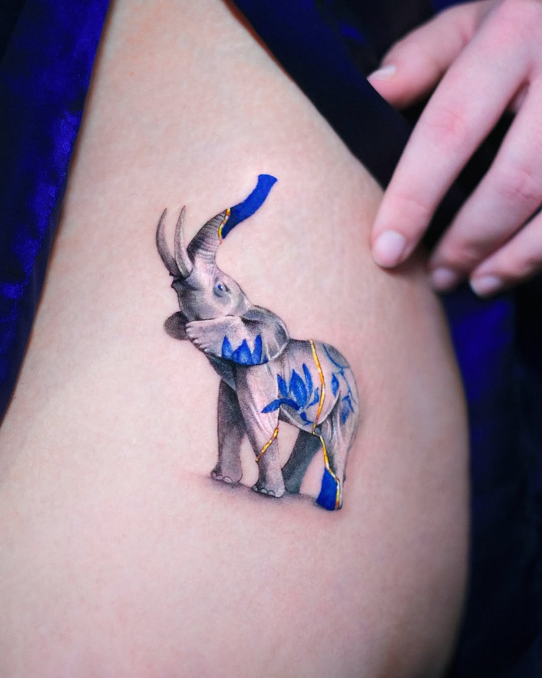 Stunning realistic elephant tattoo with blue accents Tattoo Design