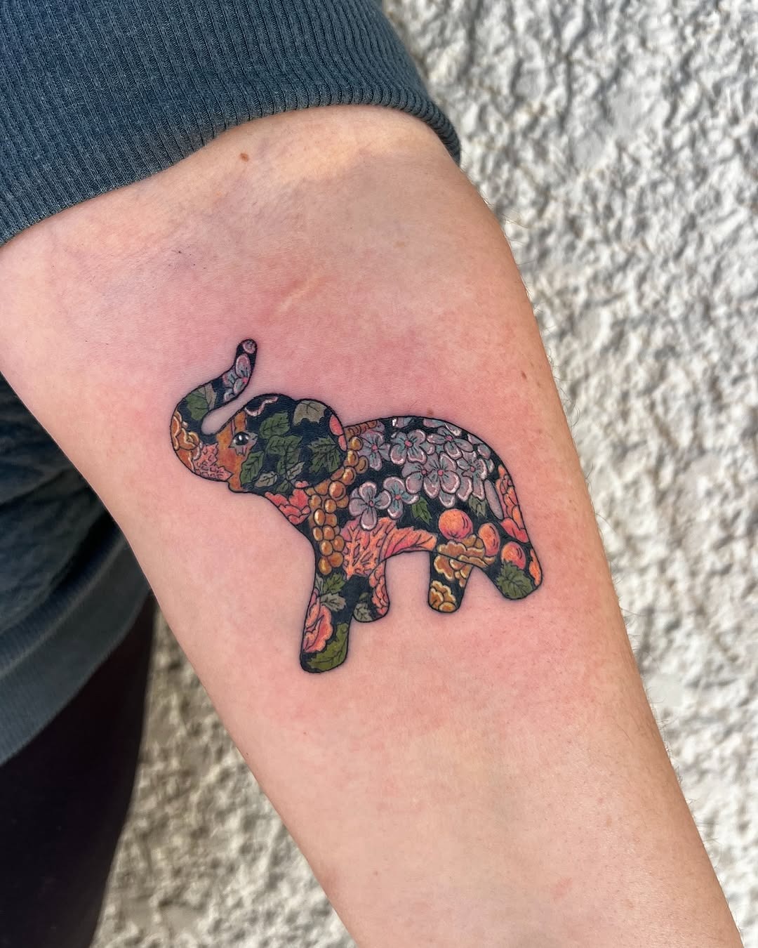 Vibrant elephant tattoo filled with floral patterns Tattoo Design
