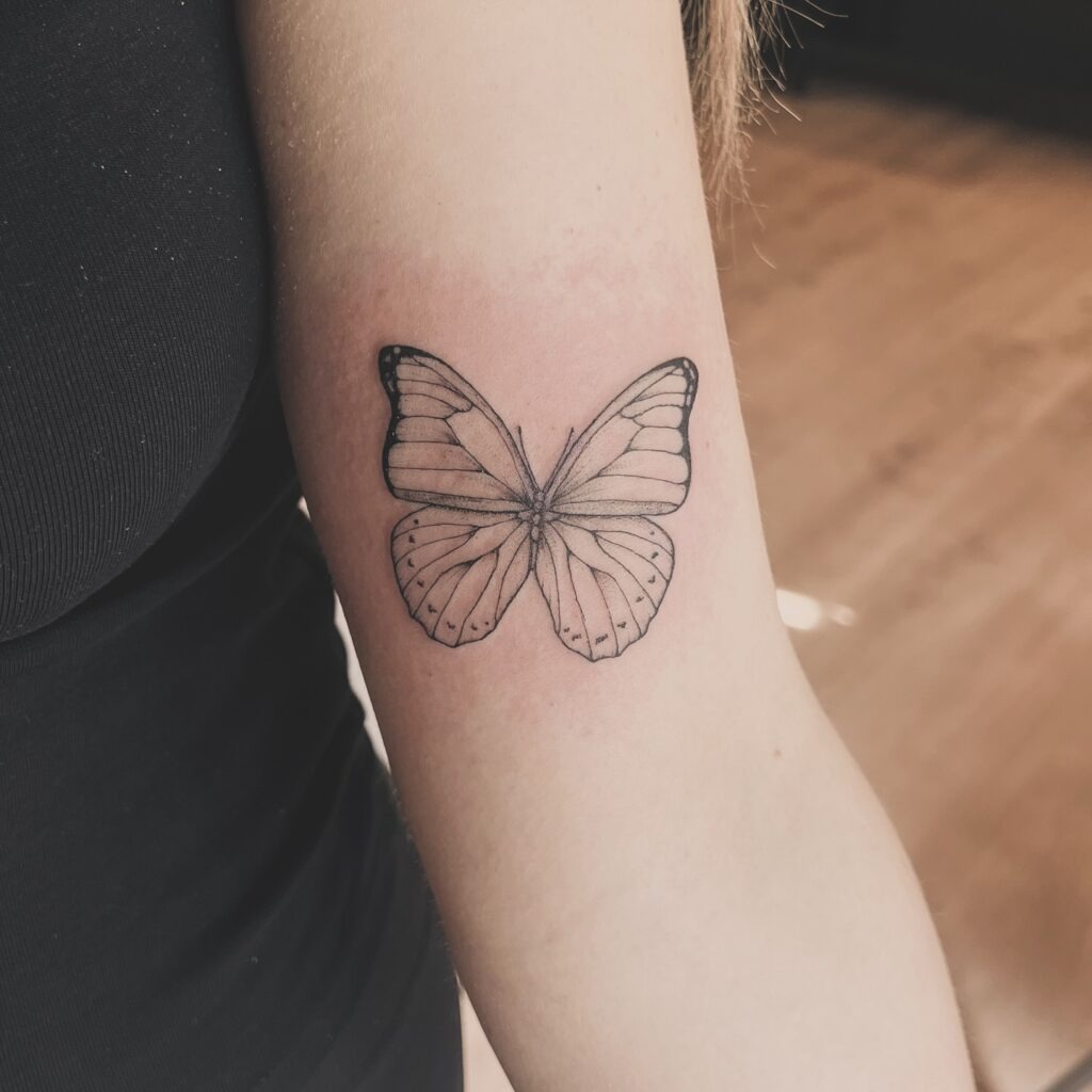 Detailed Butterfly on the Upper Arm Tattoo Design