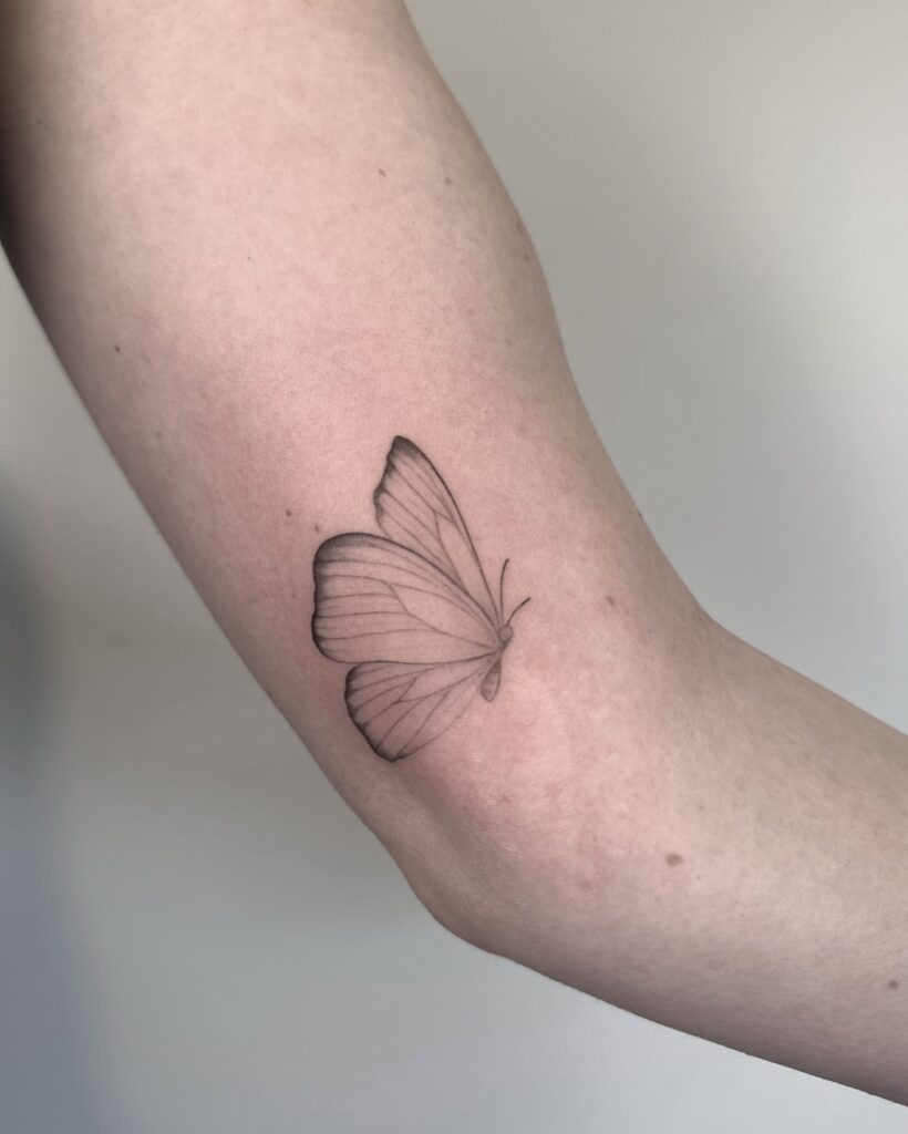 Side Profile Butterfly on the Arm Tattoo Design