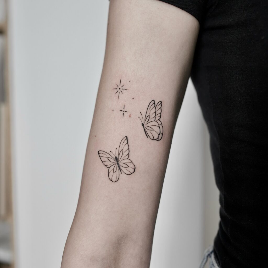 Starry Butterfly Pair on the Arm Tattoo Design