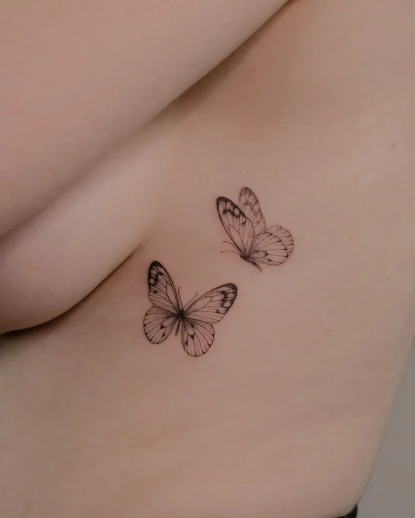 Two Fine Line Butterflies on the Rib Tattoo Design