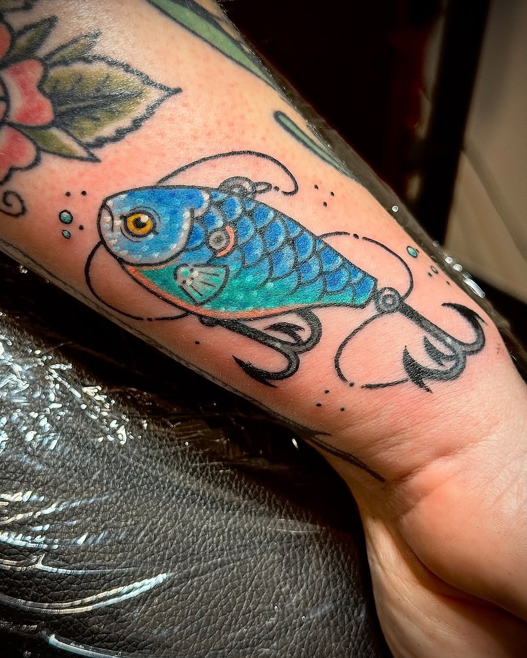 Vibrant blue fish tattoo with a fishing lure Tattoo Design