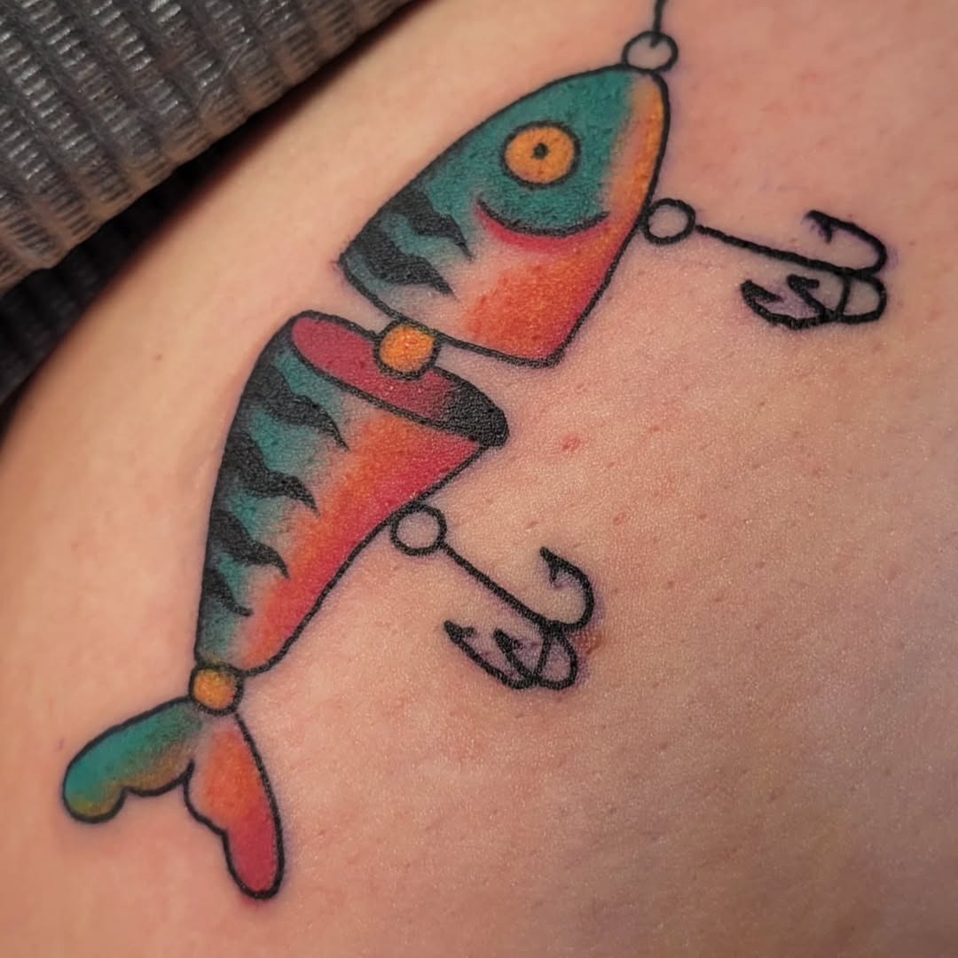 Vibrant fish tattoo with hooks and color Tattoo Design
