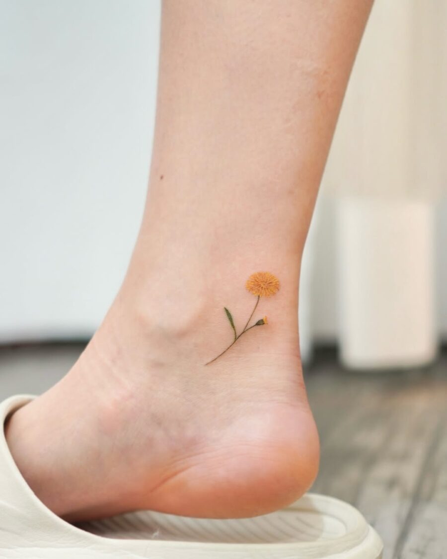 Charming yellow flower ankle tattoo for a sweet look Tattoo Design