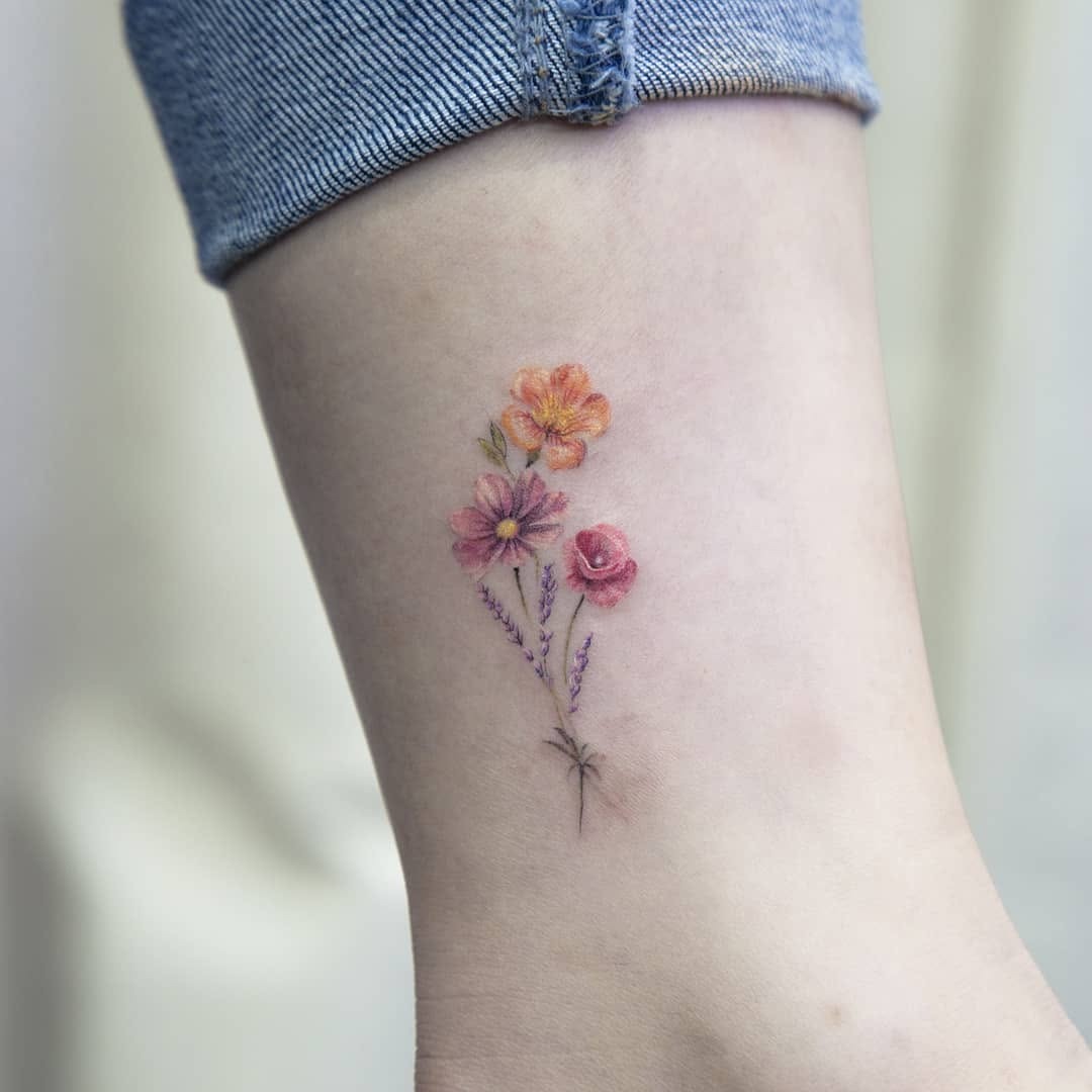 Delicate floral accents for ankle tattoos Tattoo Design