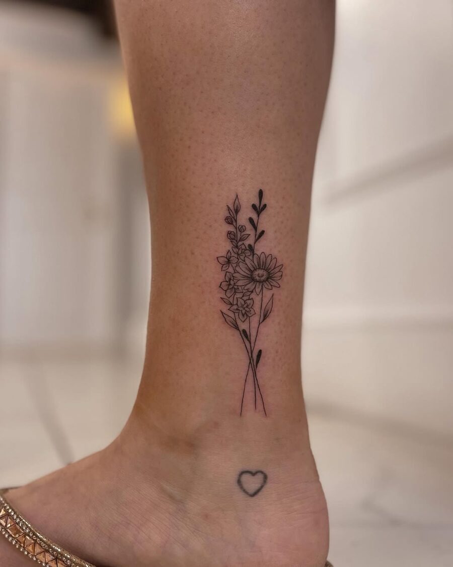 Elegant floral ankle tattoo with delicate details Tattoo Design