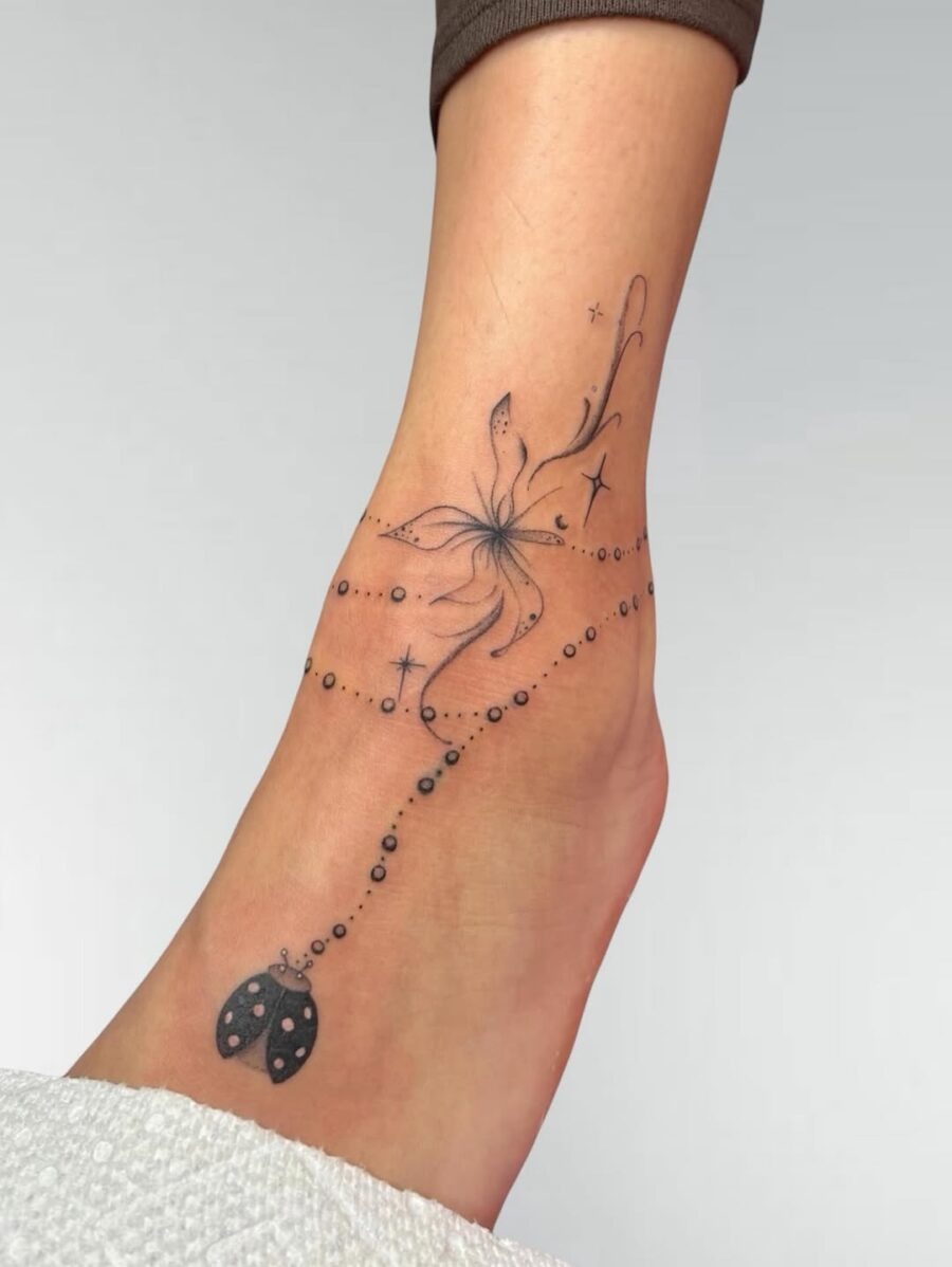 Elegant flower tattoo with whimsical accents Tattoo Design