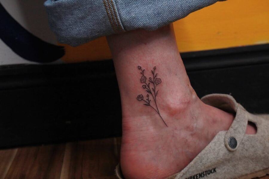 Elegant minimalistic flower ankle tattoo design Tattoo Design
