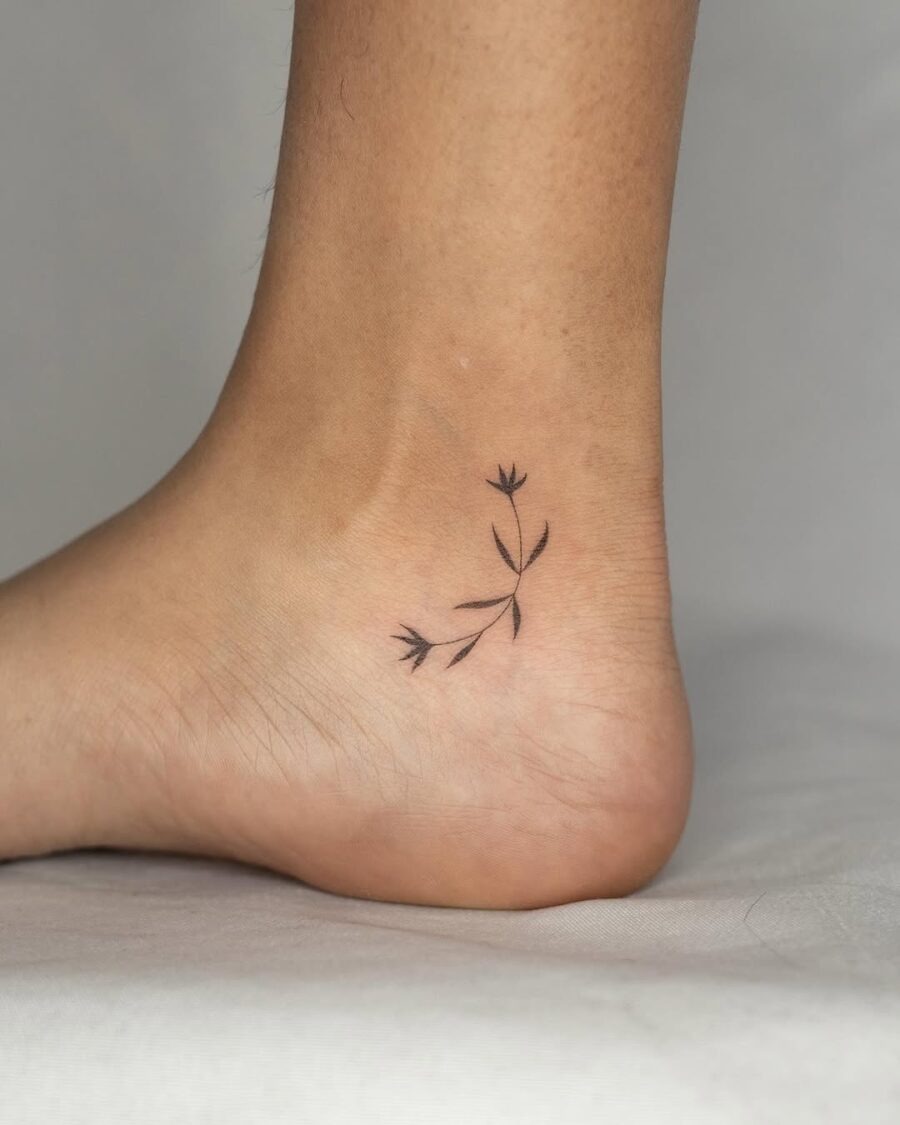 Minimalistic flower ankle tattoo with elegant curves Tattoo Design
