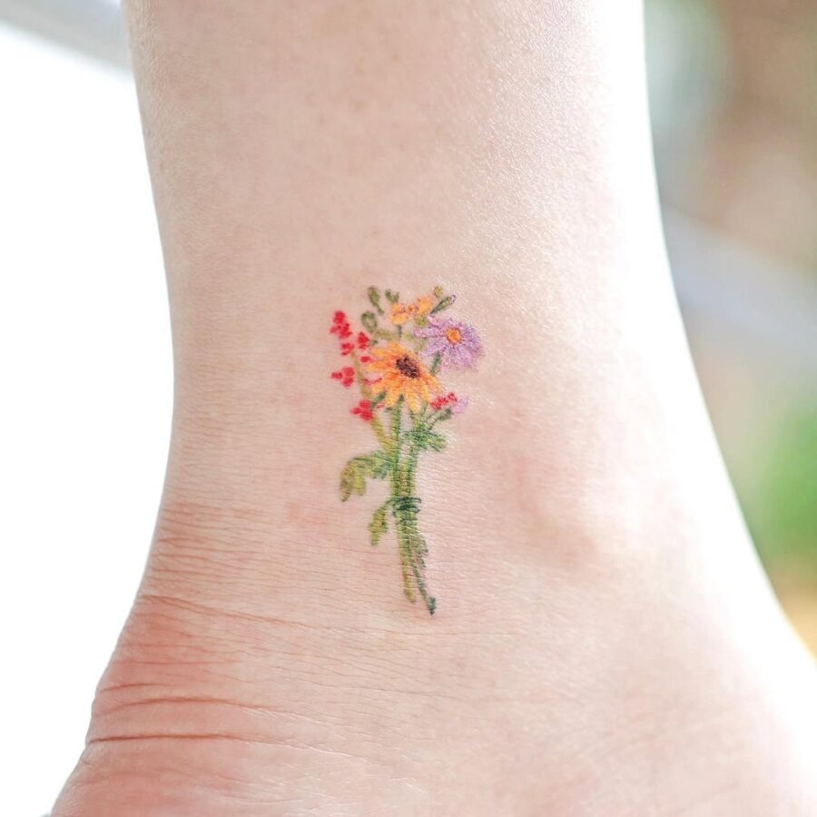 Vibrant floral ankle tattoo for nature lovers Tattoo Design