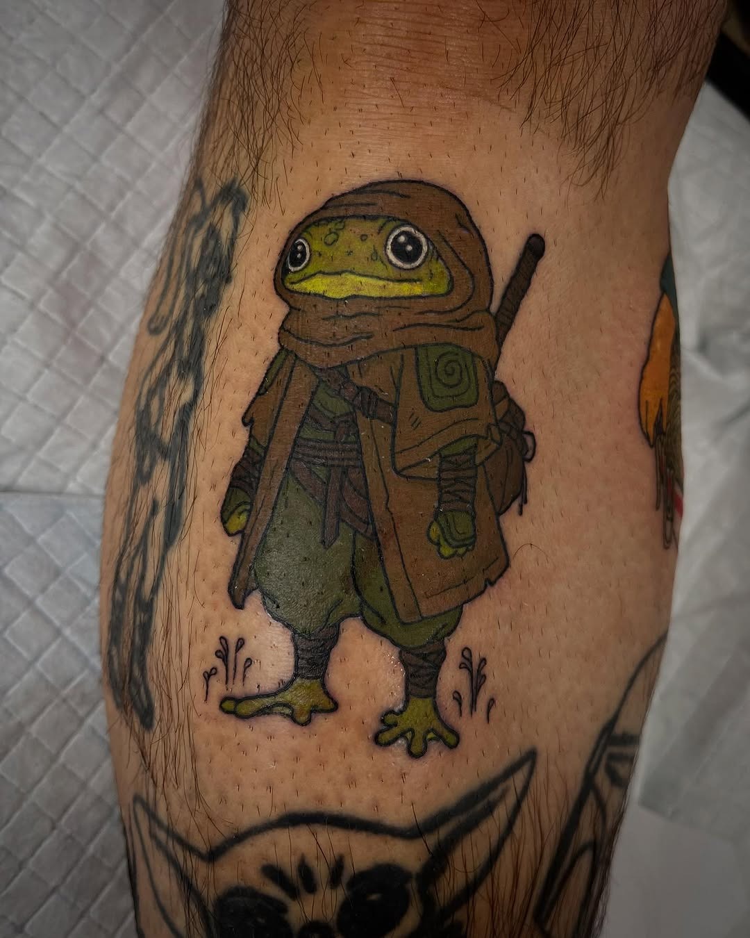 Adventurous frog tattoo with a fantasy twist Tattoo Design
