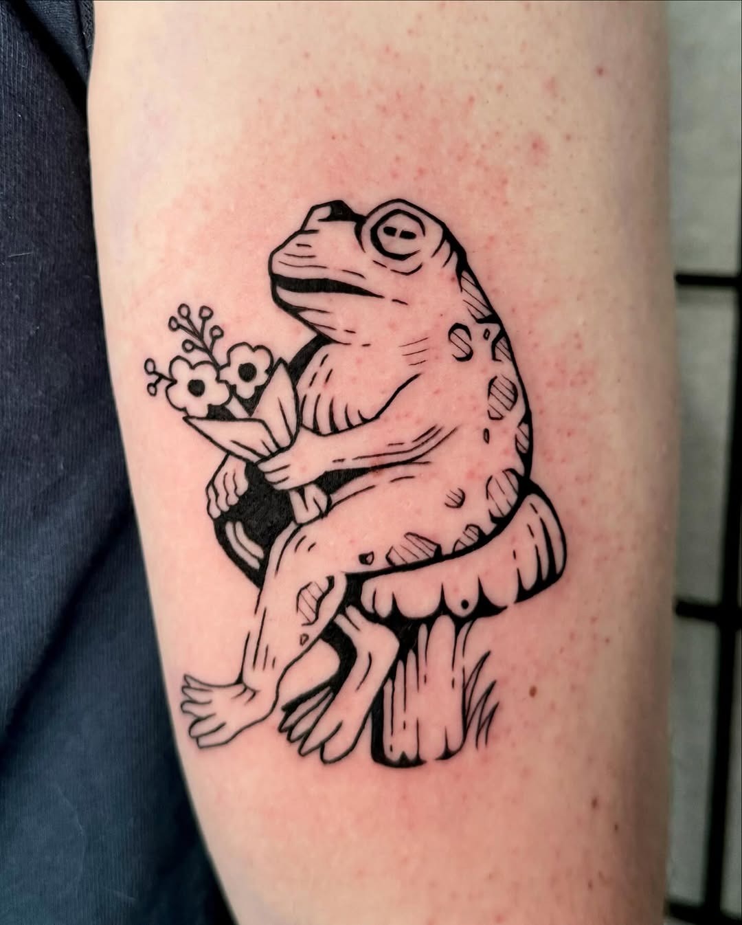 Charming frog tattoo with floral elements Tattoo Design