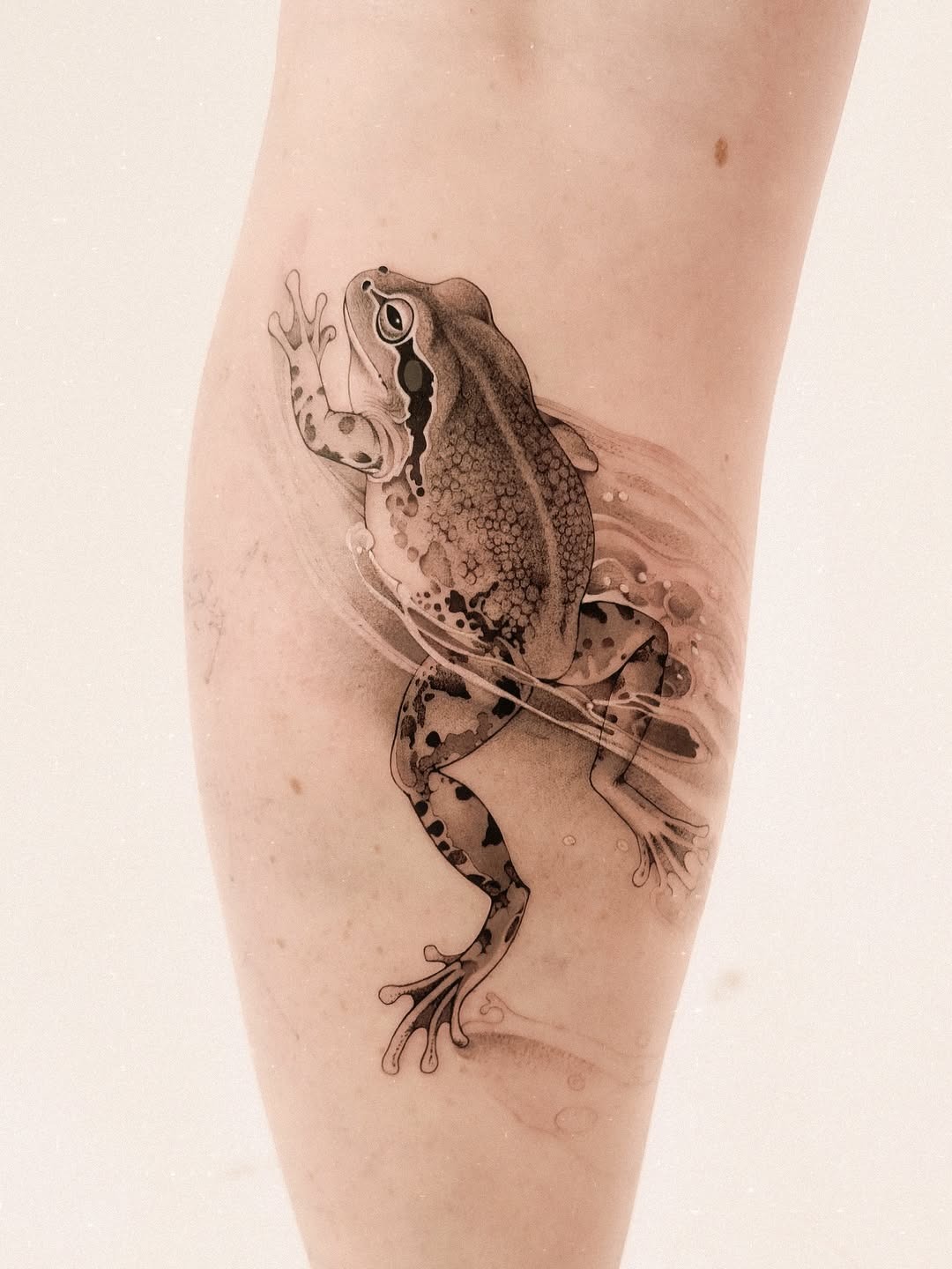 Graceful frog tattoo on smooth skin Tattoo Design