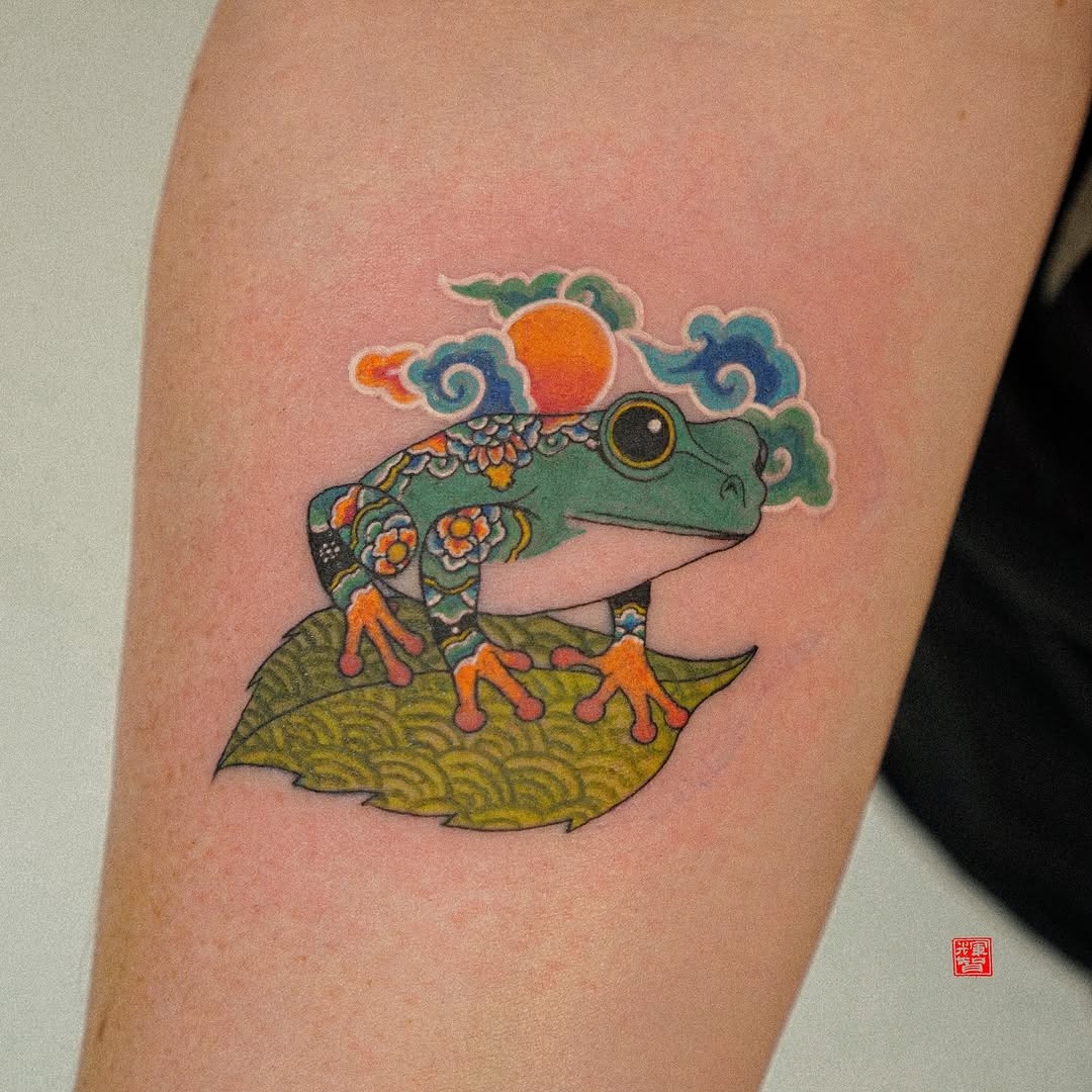 Vibrant Frog Tattoo with Floral Elements Tattoo Design
