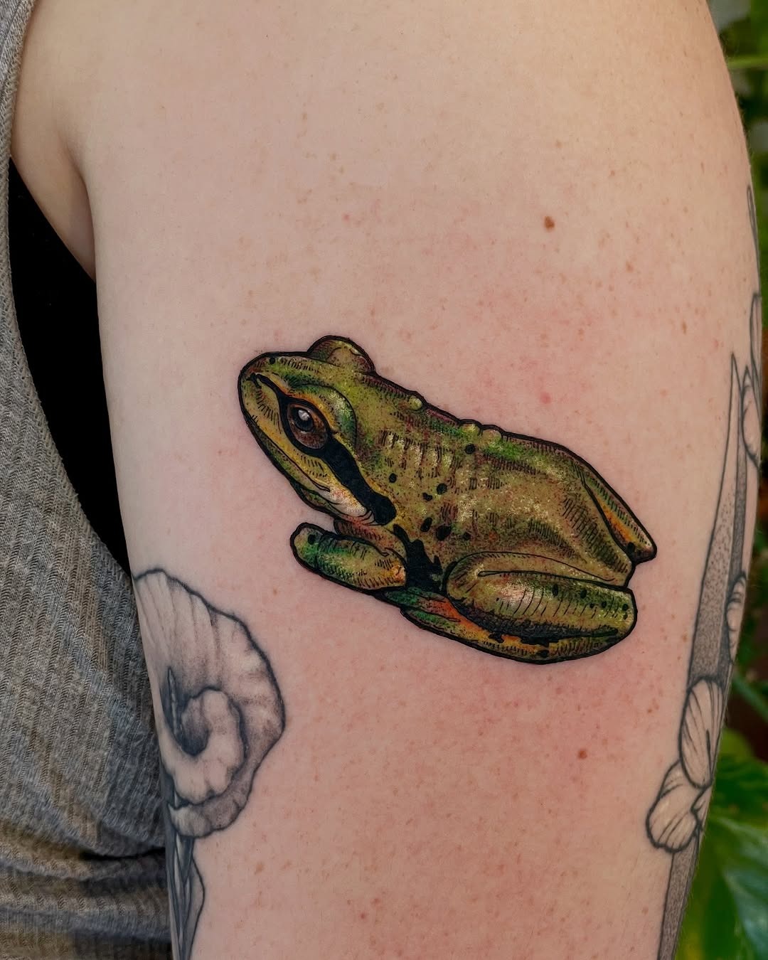 Vivid green frog tattoo on arm Tattoo Design