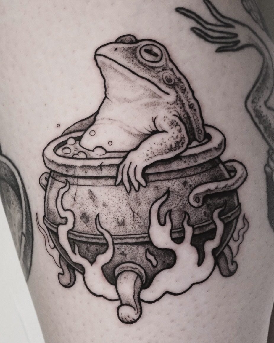 Whimsical frog lounging in a cauldron Tattoo Design