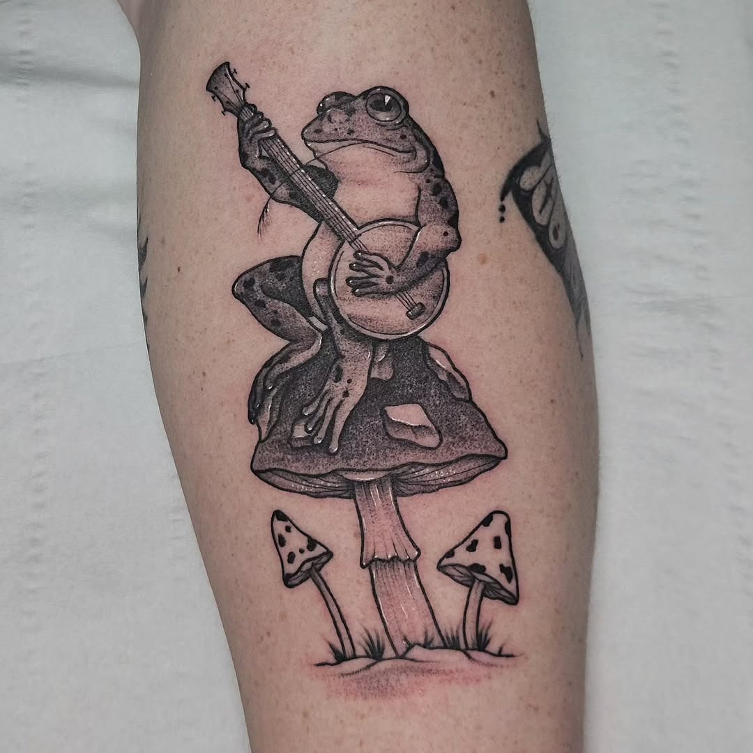 Whimsical frog tattoo playing a guitar Tattoo Design
