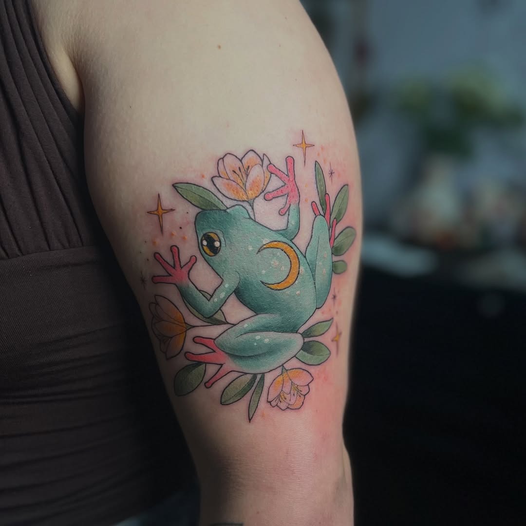 Whimsical frog tattoo with floral accents Tattoo Design