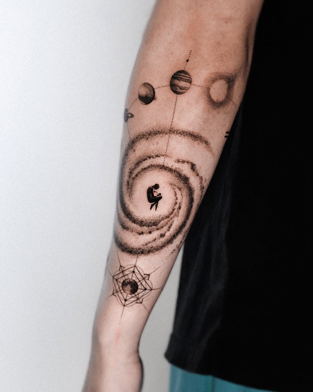 A cosmic swirl of galaxies and planets combined Tattoo Design