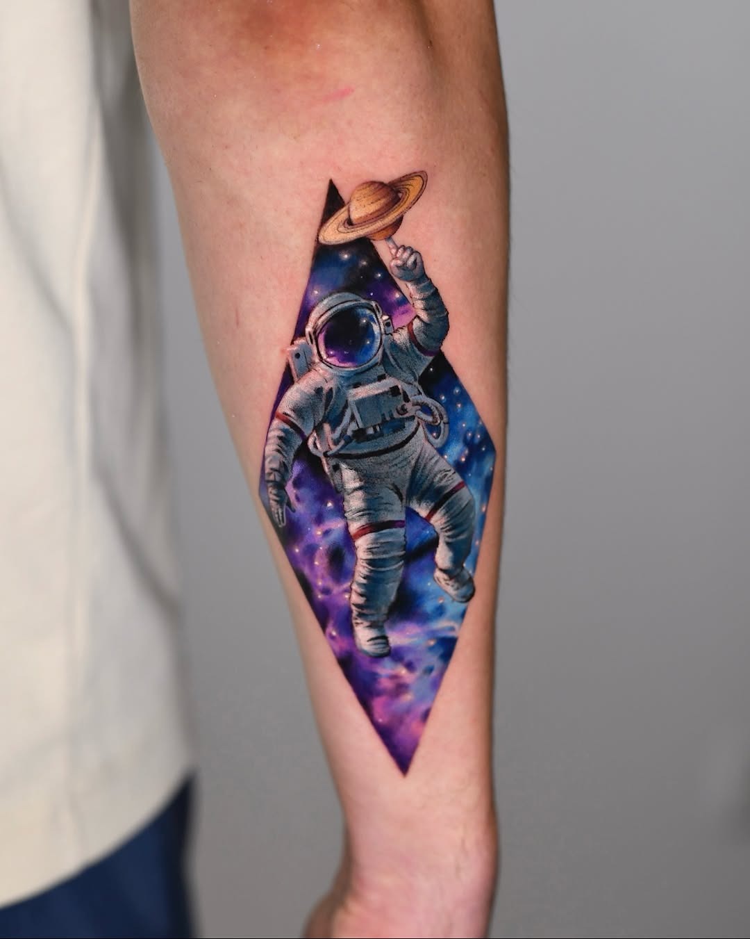 Cosmic Astronaut Surrounded by Vibrant Galaxies Tattoo Design