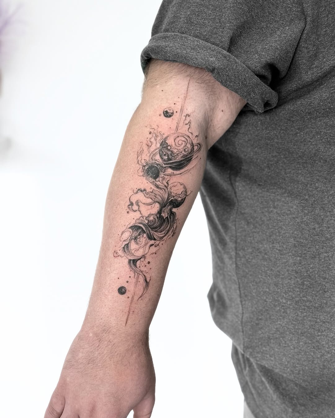 Elegant swirls capture cosmic beauty in ink. Tattoo Design