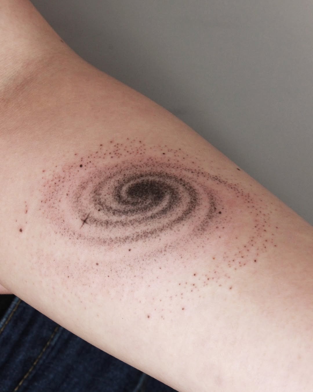 Stunning spiral galaxy tattoo design on forearm Tattoo Design