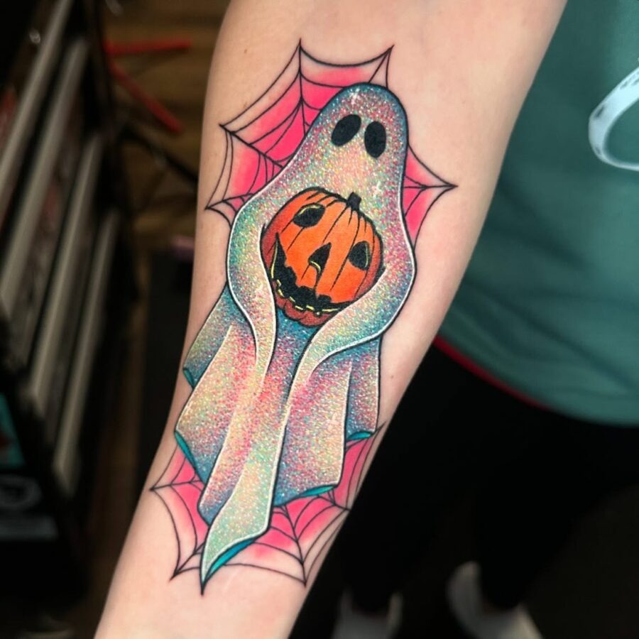 Charming ghost tattoo with vibrant pumpkin design Tattoo Design