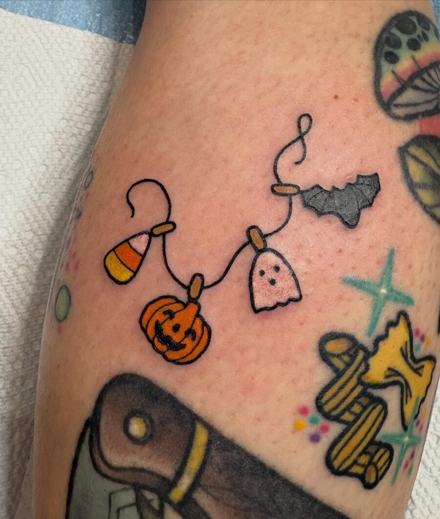 Colorful Halloween-themed tattoo design with charm vibes Tattoo Design