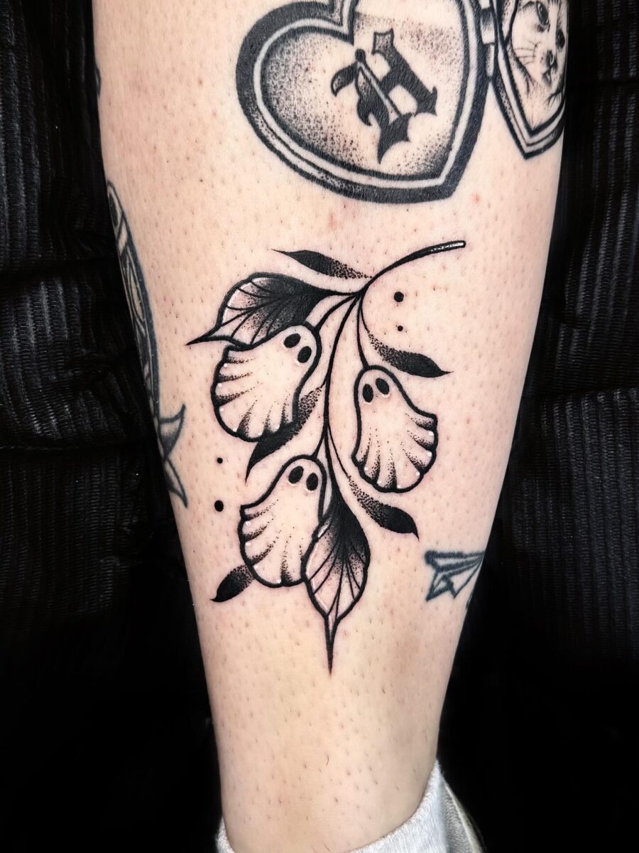 Eerie flora with ghostly elements in tattoo art Tattoo Design