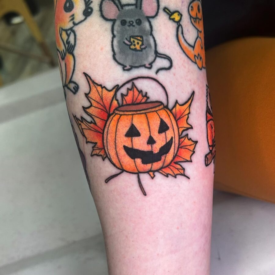 Playful pumpkin tattoo with autumn leaves vibes Tattoo Design