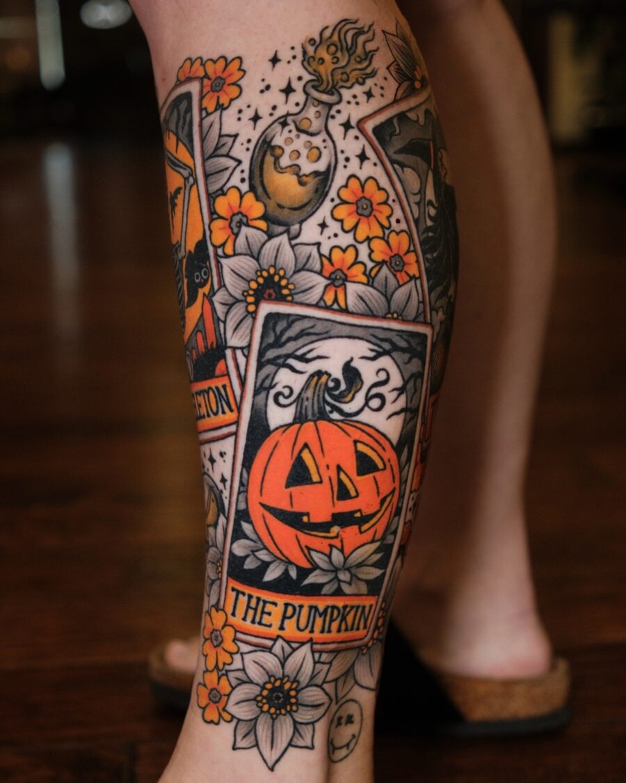 Unique pumpkin tattoo surrounded by flowers Tattoo Design