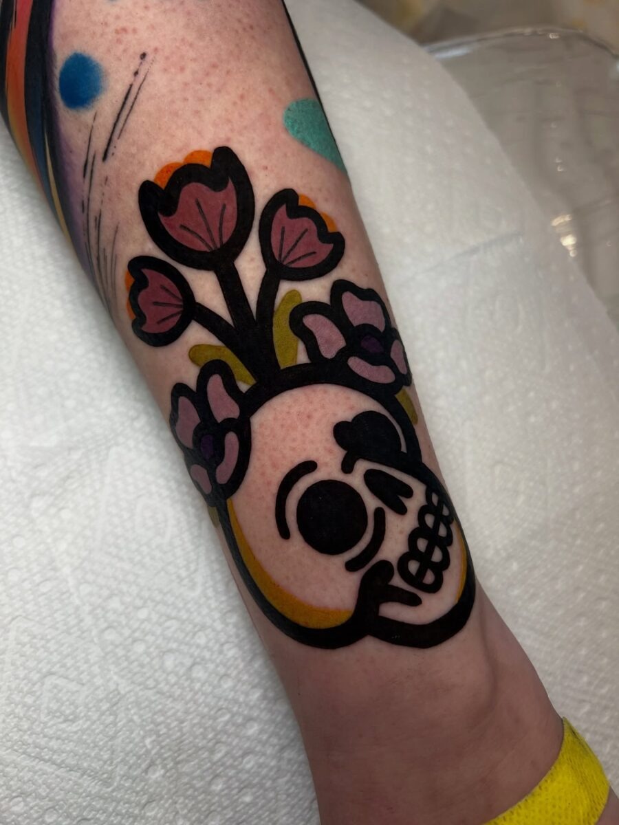 Whimsical skull with floral accents and colors Tattoo Design