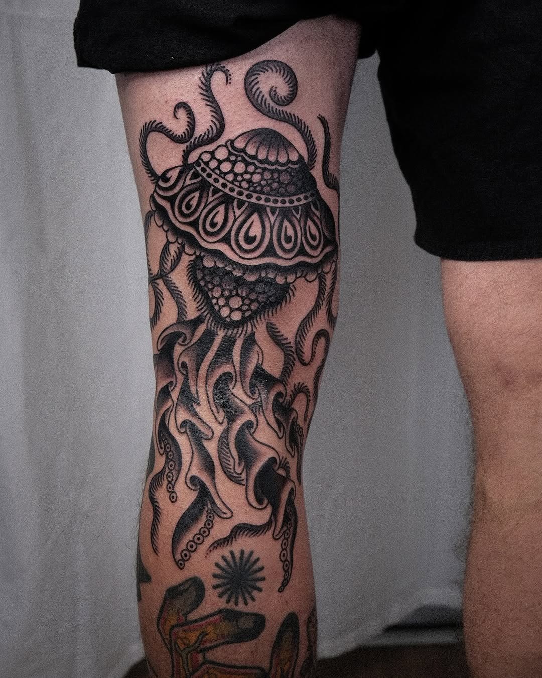 Elegant black ink jellyfish tattoo on leg Tattoo Design